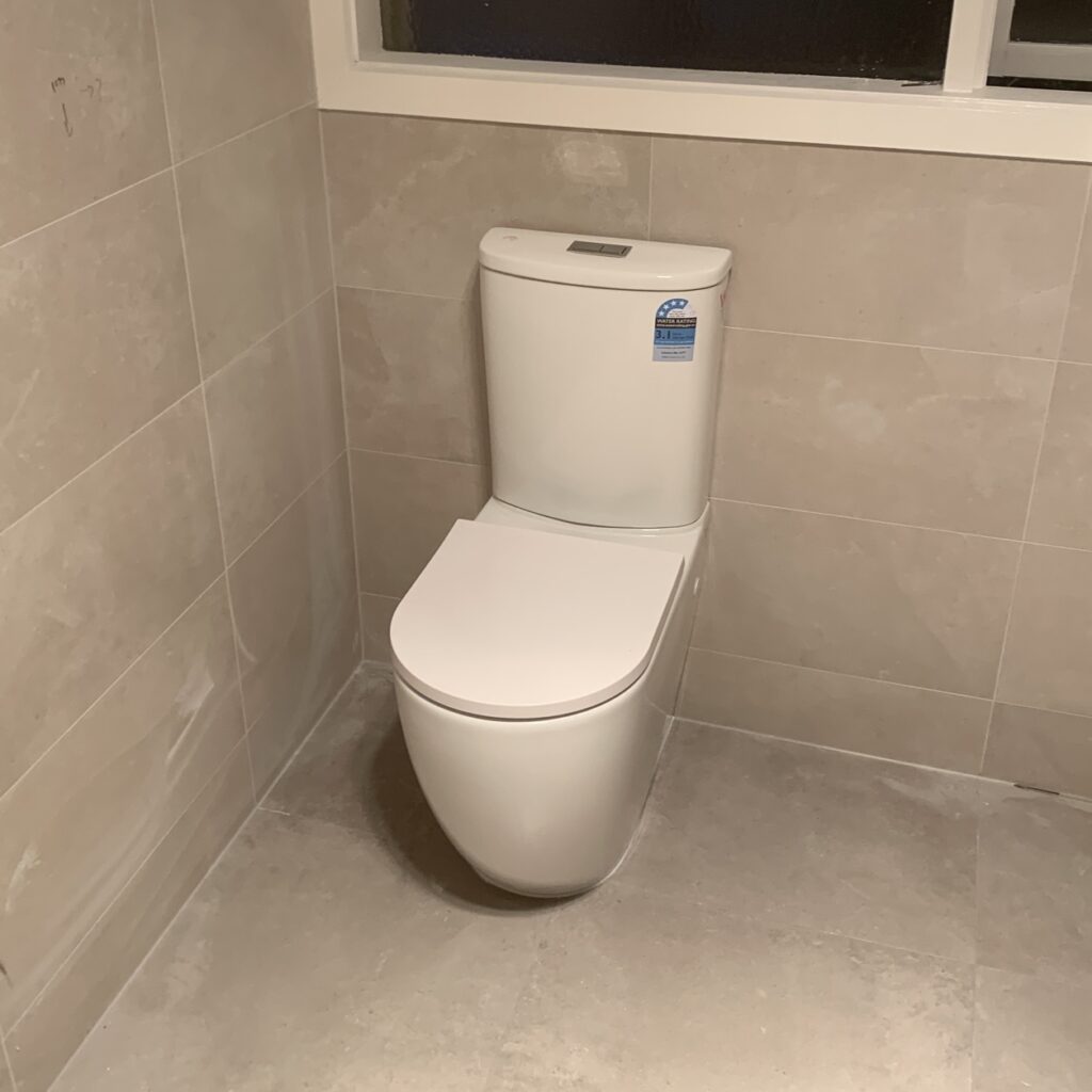 New back-to-wall toilet suite installed in a renovated tiled bathroom