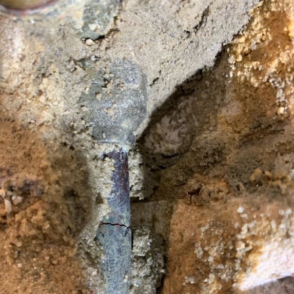 Cracked water pipe found inside a concrete shower wall in Glen Iris