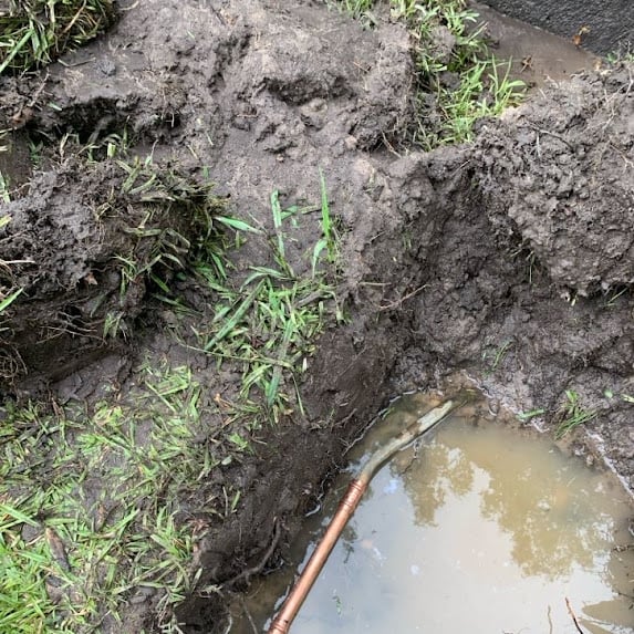 Underground copper water pipe repair completed in a Camberwell front garden.