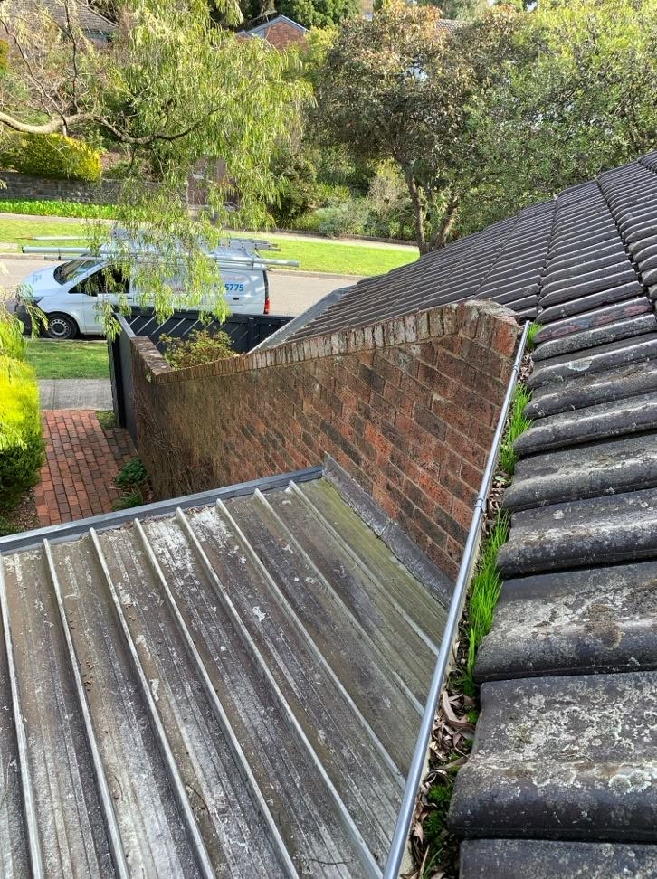 Roof plumbing repair area at a Burwood home with Doherty Plumbing service van nearby.