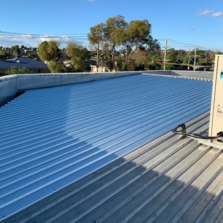Completed partial metal roof replacement at a Burwood commercial property.