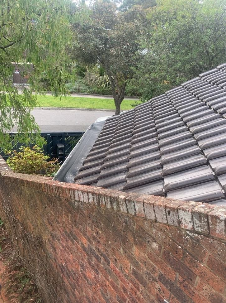 Roof edge and tiled roof at a Burwood property after clearing and repair work.
