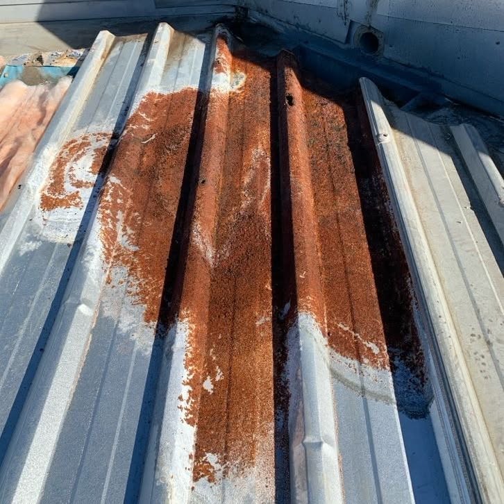 Corroded commercial metal roofing before partial roof replacement in Burwood.