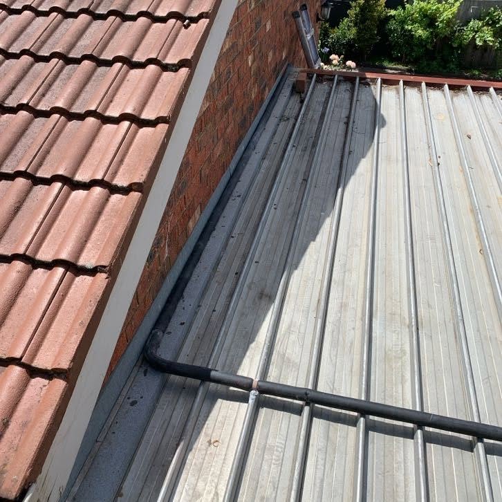 New water supply bypass line installed over a garage roof in Burwood.