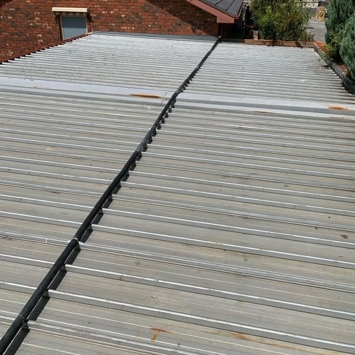 Water supply pipe routed across a garage roof in Burwood.