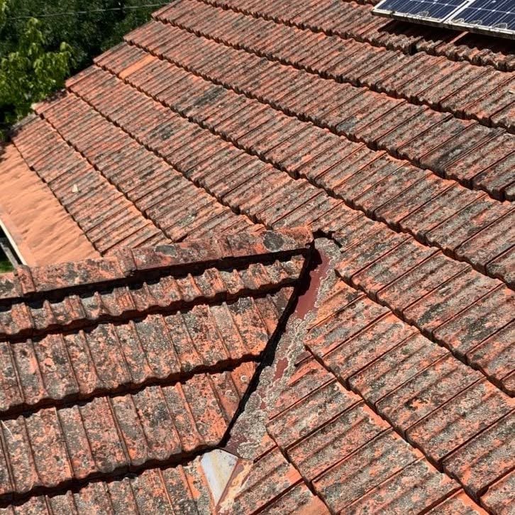 Open roof junction with deteriorated sealing on a terracotta tiled roof in Glen Iris.